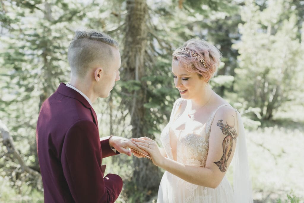 A bride slips a ring on her grooms finger during their wedding ceremony in Mammoth Lakes. 