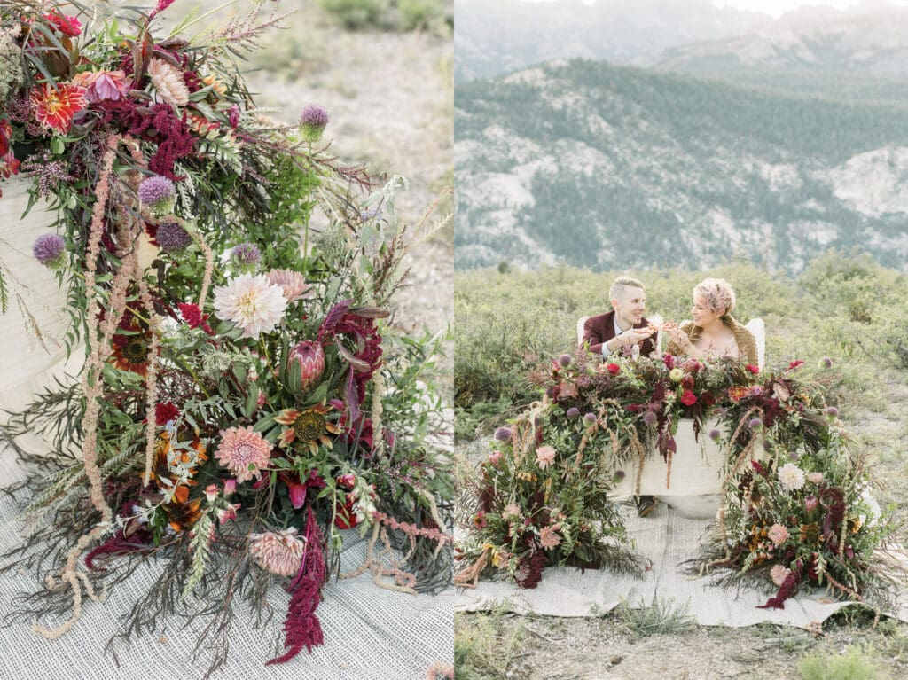 A bride and groom pizza cheers while seated at a table decorated with luxuriously flowers, all while in view of the mountain peaks at Mammoth Lakes. 