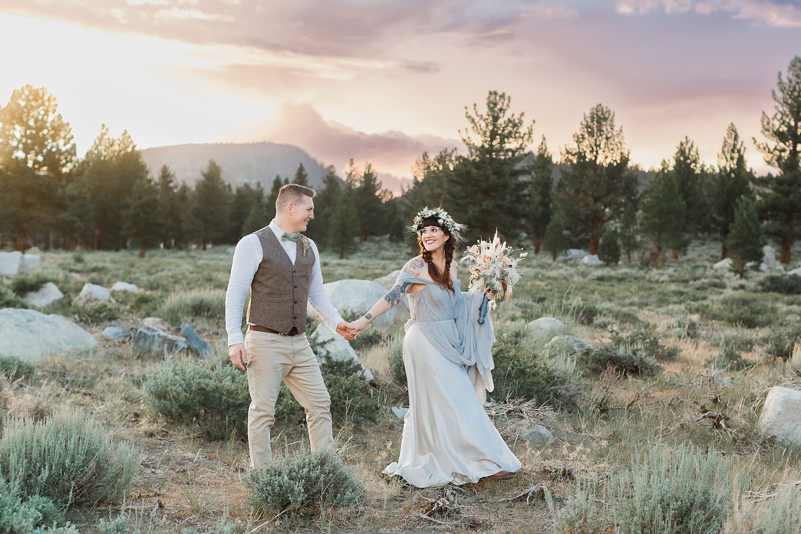 A bride and groom take a walk at sunset on their Mammoth Lakes Wedding.