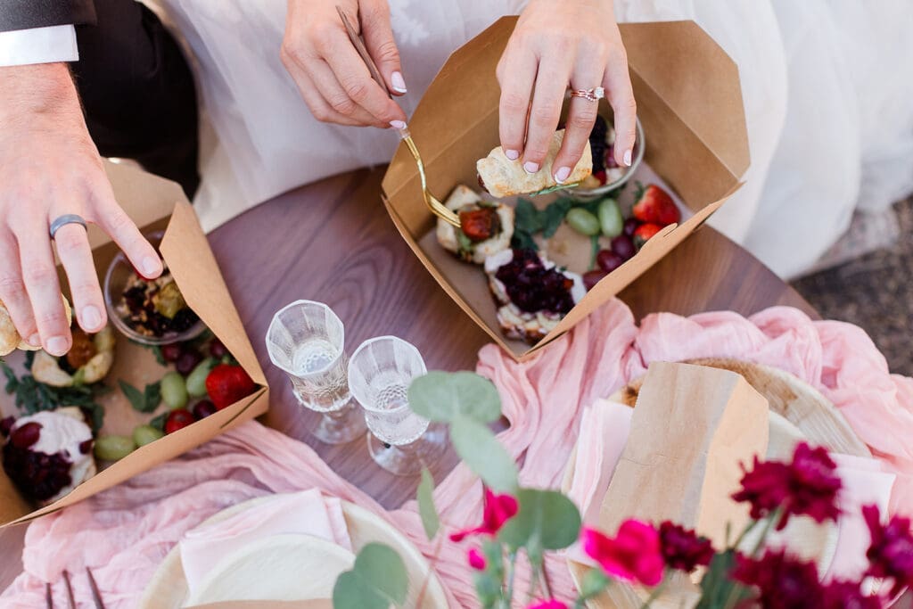 A bride and groom eat their catered lunch at Cathedral Beach in Yosemite National Park.