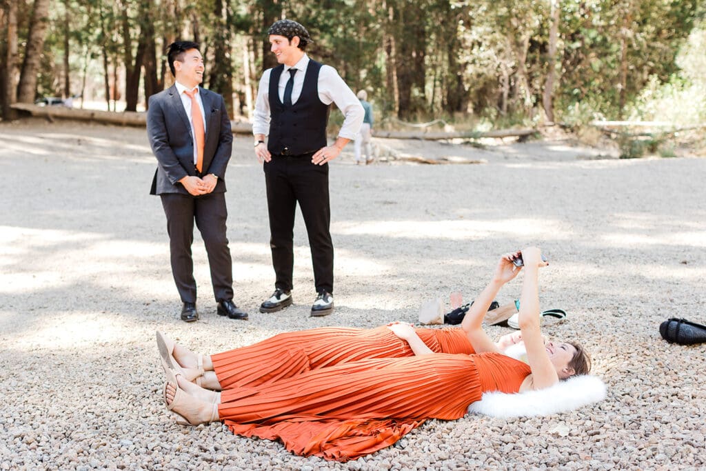 Wedding guests lay on the shore of Cathedral beach in Yosemite