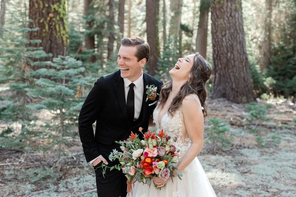 A bride and groom overcome with laughter on their wedding day in Yosemite National Park