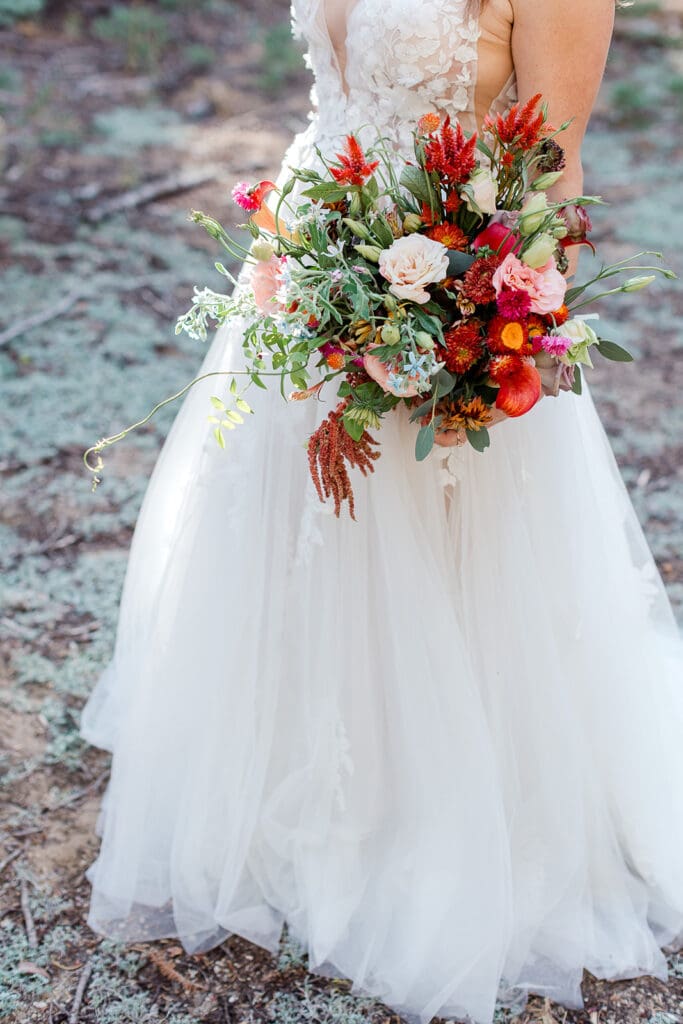 A bride holds a colorful bouquet on her wedding day in Yosemite