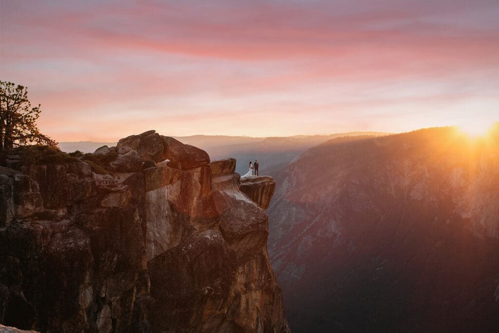 A couple at Taft Point during a stunning Yosemite sunset.