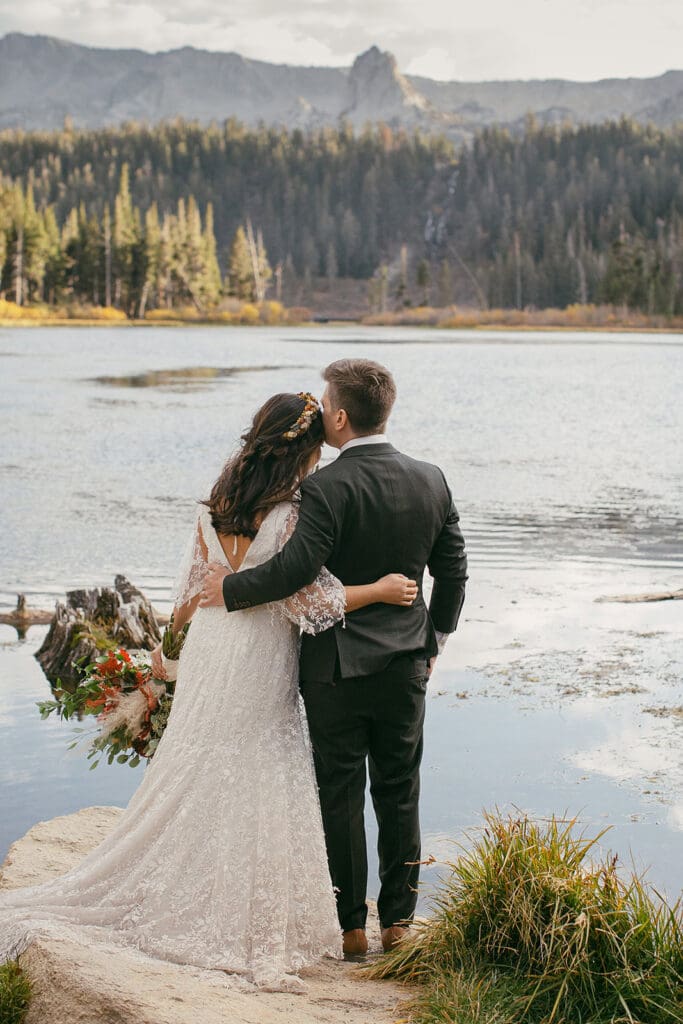 A bride and groom take in the view at Twin lakes on their Mammoth Lakes Wedding day.