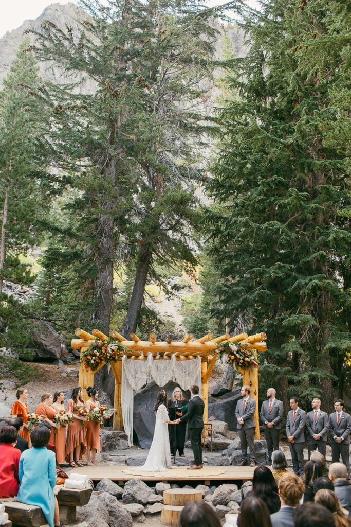 A bride and groom say their vows at their Forest Chapel wedding at Twin Lakes in Mammoth.