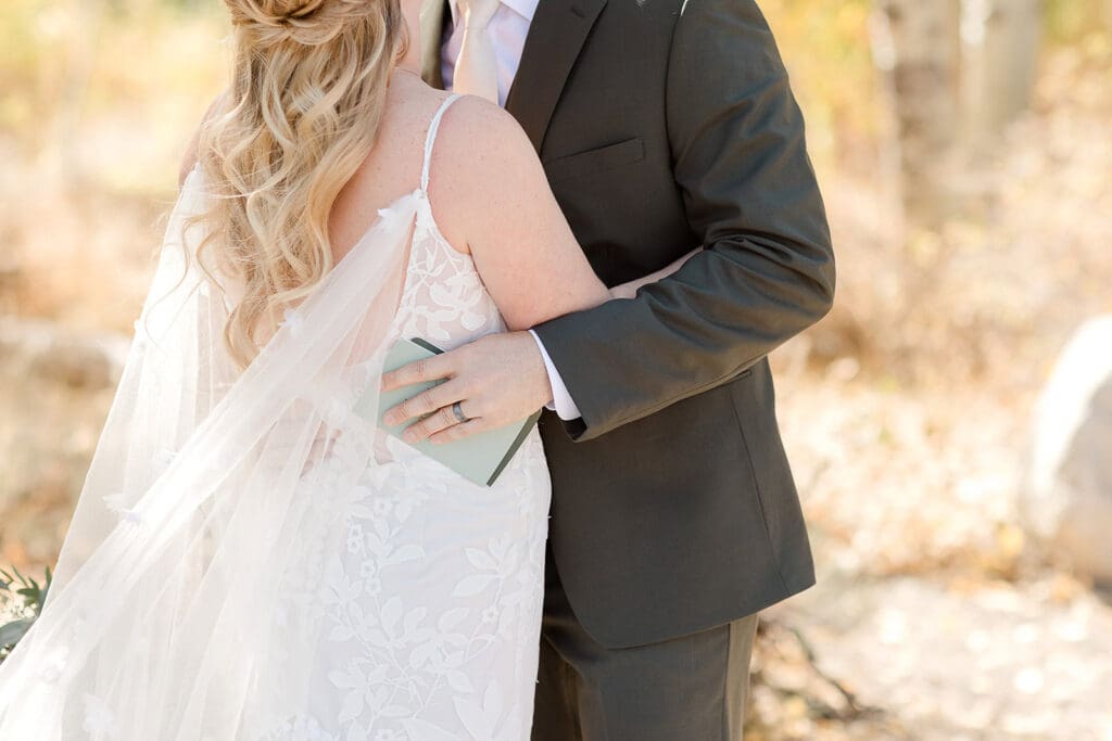 A groom holds his bride on their Mammoth Lakes Wedding day.