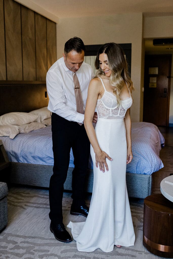 A bride and groom get ready together at the Westin Monache in Mamomth on their Wedding day.