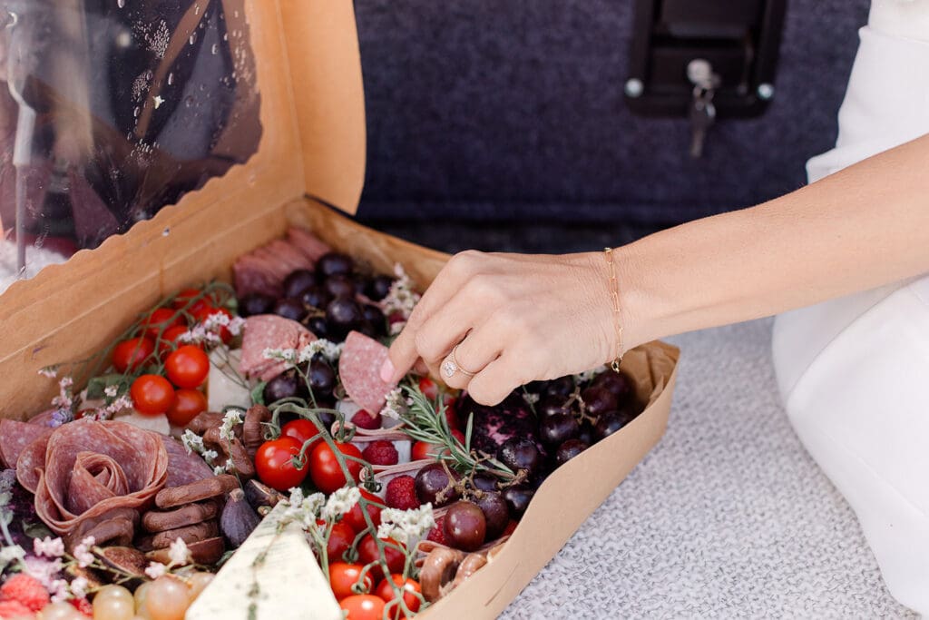 A bride shares charcuterie on her Mammoth Lakes Wedding day.