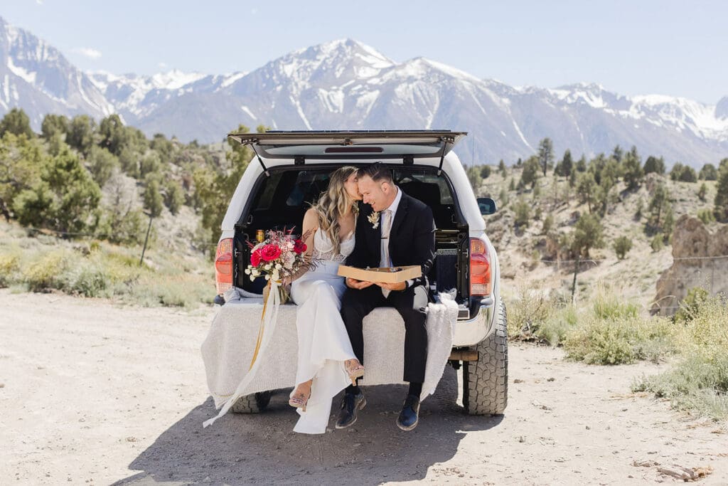 A bride and groom share charcuterie on her Mammoth Lakes Wedding day.