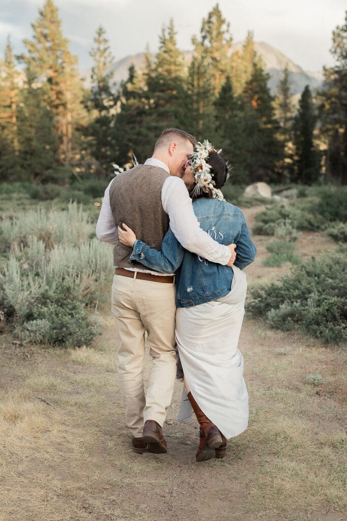 A bride and groom take a walk on their wedding day in Mammoth Lakes.