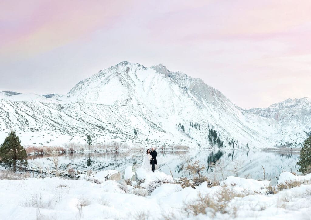 Couple enjoys their snowy, winter elopement day at Convict Lake in Mammoth Lakes.
