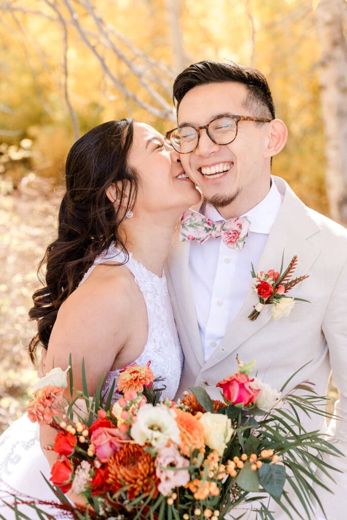 A bride kisses her groom on a fall day in Mammoth Lakes.