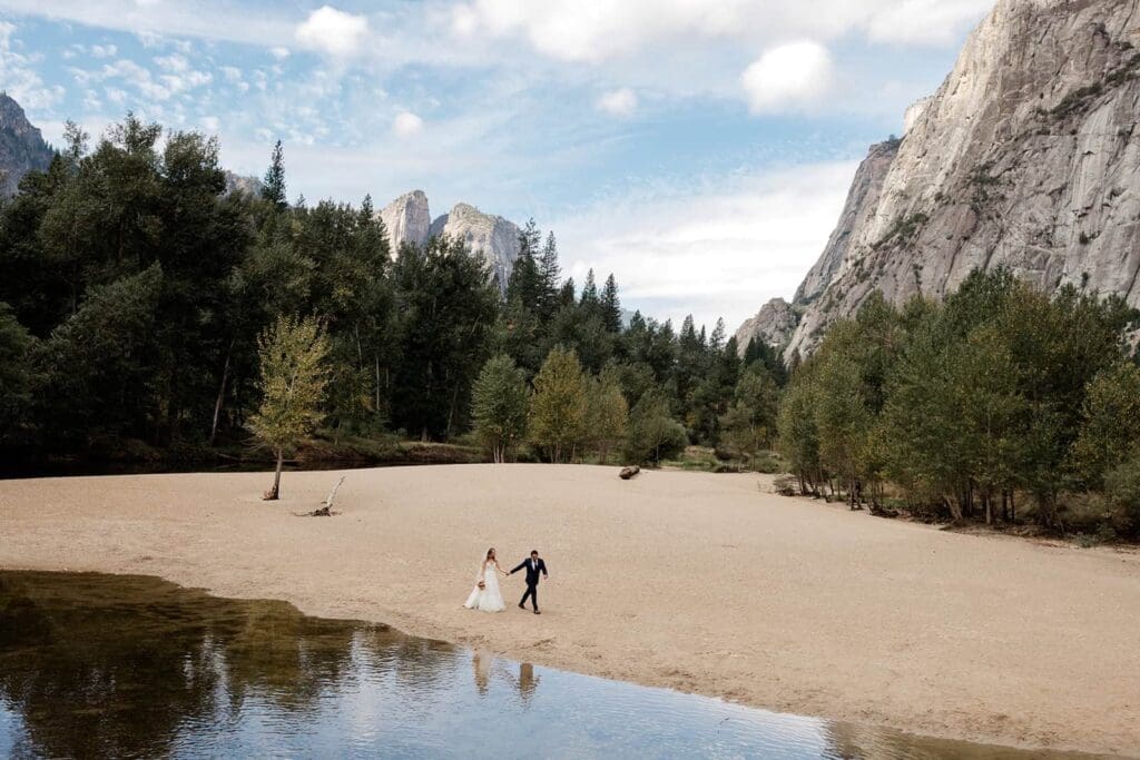 A bride and groom take a walk at Swinging Bridge Picnic Area in Yosemite.