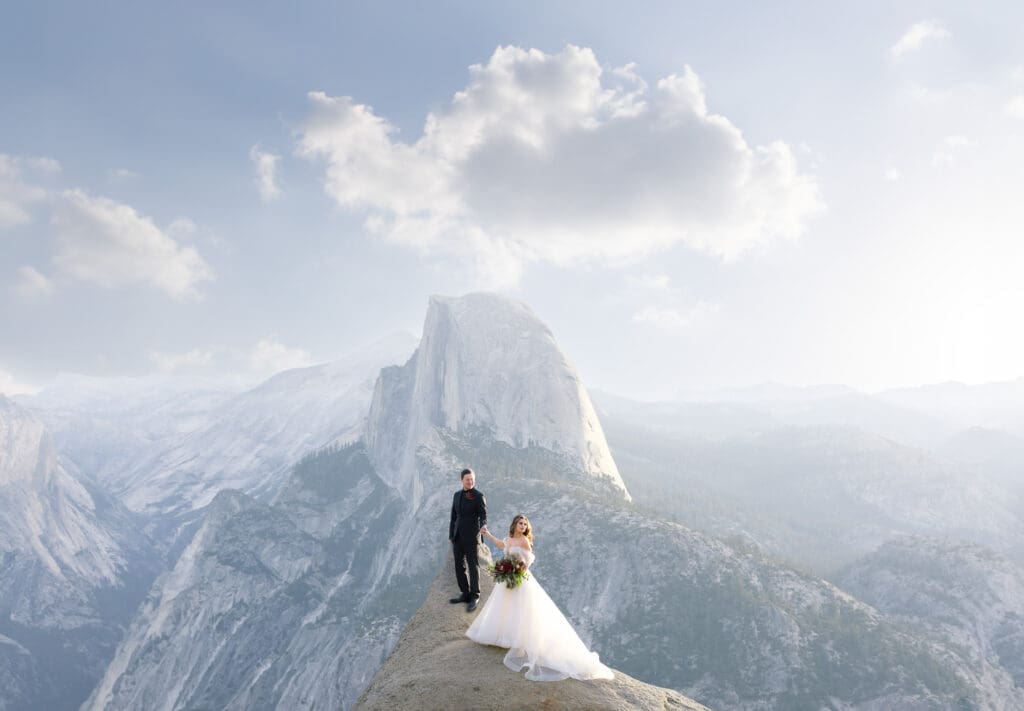 wedding couple in front of half dome from glacier point